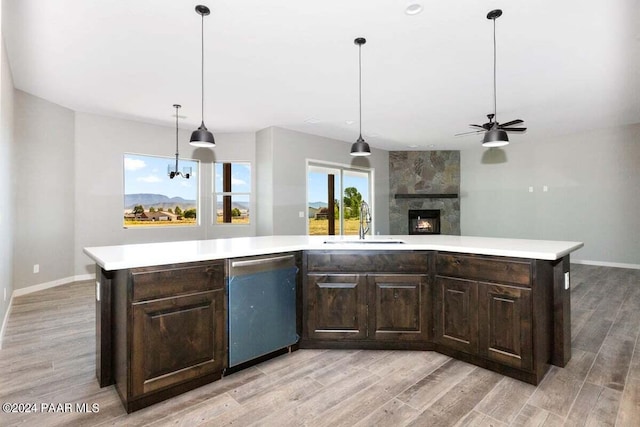 kitchen featuring dark brown cabinets, a center island, and light hardwood / wood-style floors