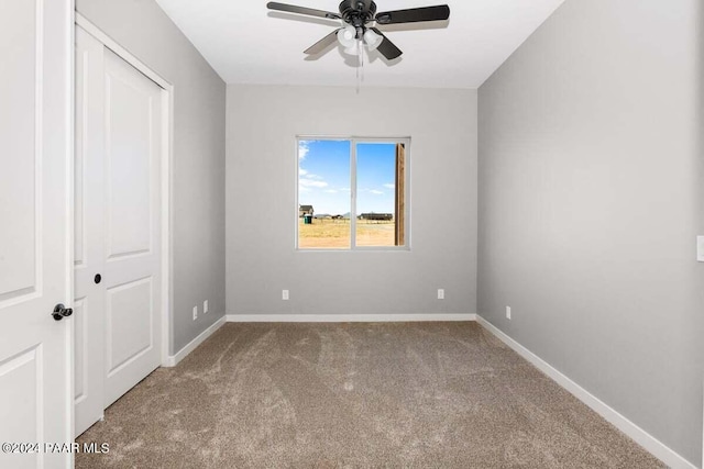 unfurnished bedroom with carpet flooring, ceiling fan, and a closet