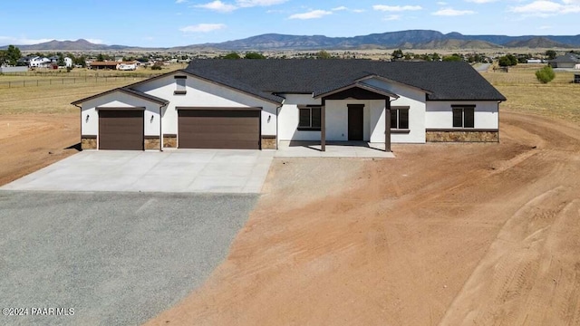 view of front facade with a mountain view and a garage