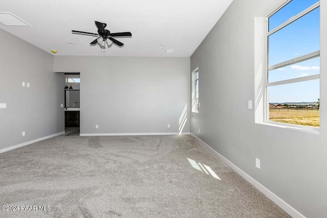 unfurnished room with carpet flooring and ceiling fan