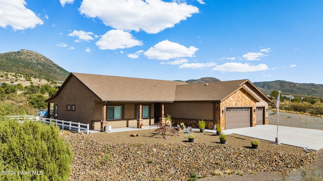 view of front of property featuring a mountain view and a garage