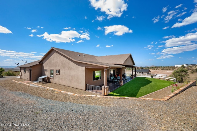 view of property exterior with a yard and a patio area