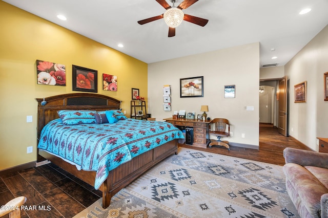 bedroom with ceiling fan and dark wood-type flooring