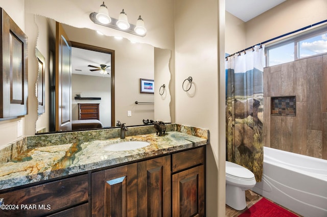 full bathroom featuring vanity, shower / bathtub combination with curtain, toilet, and ceiling fan