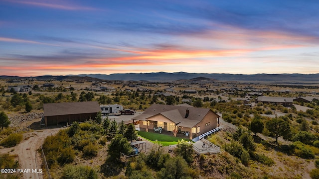 aerial view at dusk featuring a mountain view