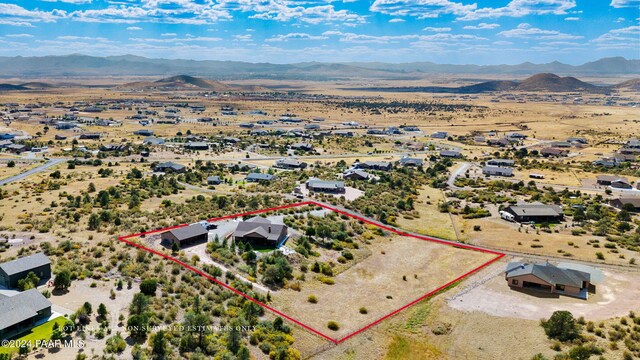 9757 N Heartland Dr, Prescott Valley, AZ 86315 - aerial view of property and surrounding area with property boundaries highlighted and a mountain backdrop