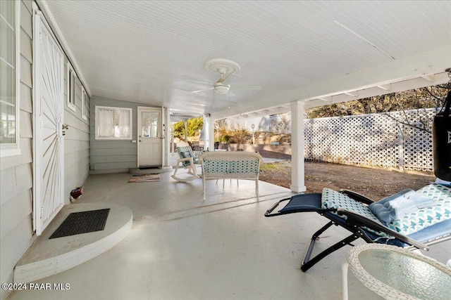 unfurnished sunroom featuring ceiling fan and lofted ceiling