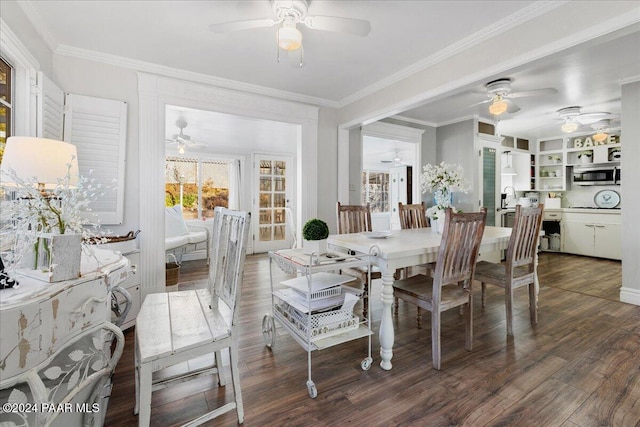 dining room with dark hardwood / wood-style floors, sink, and crown molding