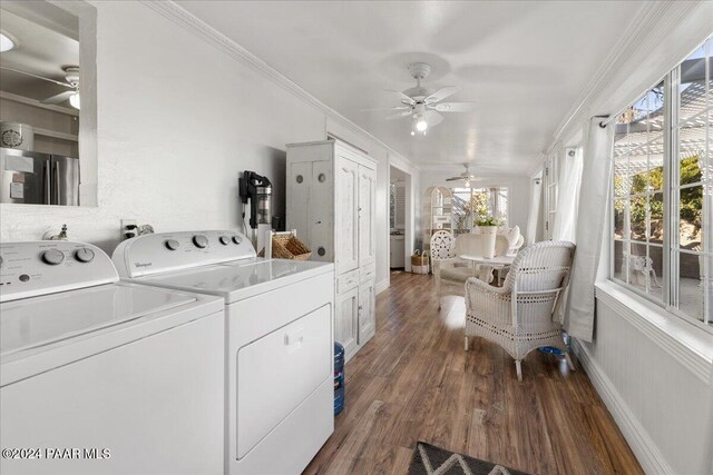 laundry area featuring dark hardwood / wood-style flooring, independent washer and dryer, and crown molding