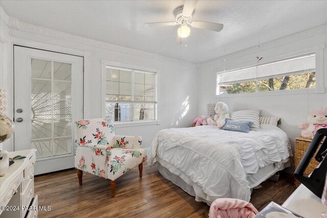 bedroom with dark hardwood / wood-style floors and ceiling fan