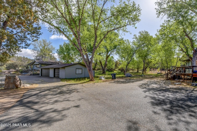 2008 N Williamson Valley Rd, Prescott, AZ 86305 - view of front of home with asphalt driveway, an outbuilding, and a wooden deck