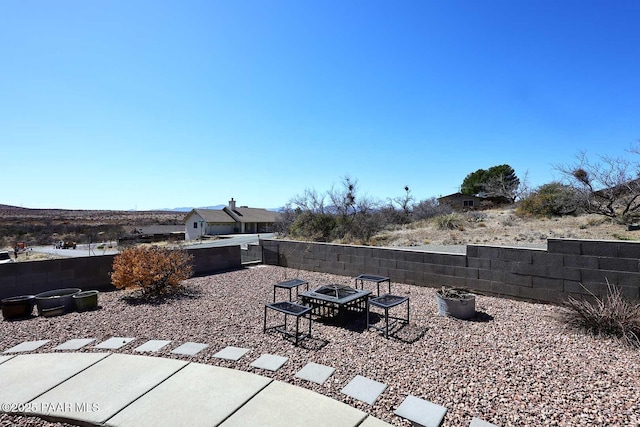 view of patio / terrace featuring a fire pit and fence