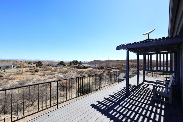 deck with a mountain view and a pergola