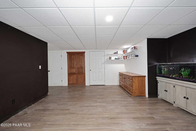 interior space featuring light wood-style flooring and a paneled ceiling