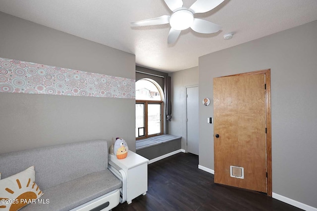 entryway with a ceiling fan, baseboards, and dark wood-style flooring