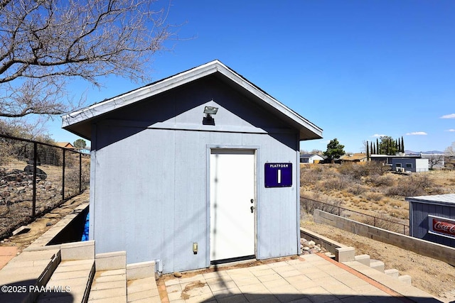 view of shed with fence