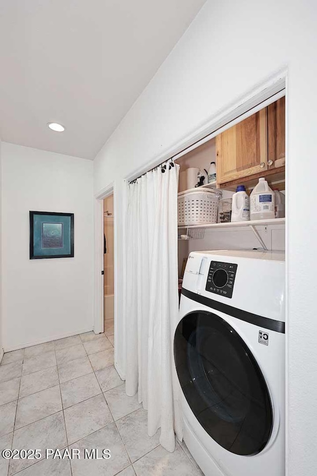 laundry room featuring washer / dryer, light tile patterned floors, and laundry area