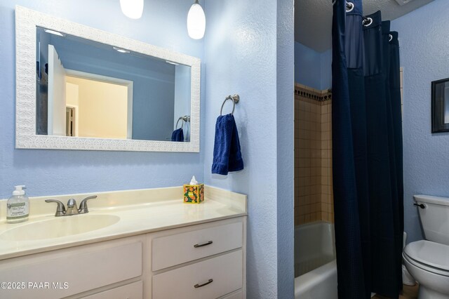 1434 Haisley Ct, Prescott, AZ 86303 - full bath with toilet, vanity, a textured wall, and shower / bath combo with shower curtain