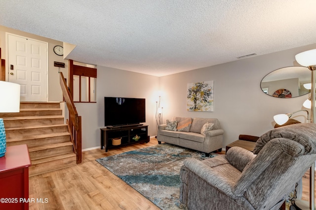 1434 Haisley Ct, Prescott, AZ 86303 - living area with light wood-type flooring, a textured ceiling, stairway, and baseboards