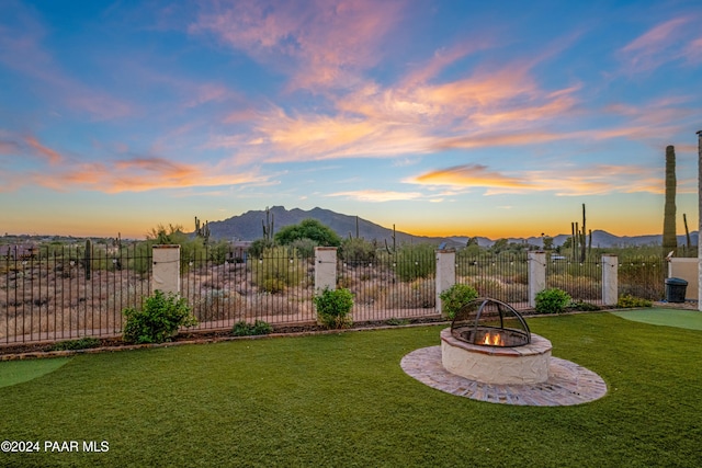 yard at dusk with a mountain view and an outdoor fire pit