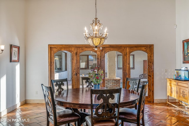 dining room featuring a high ceiling and an inviting chandelier