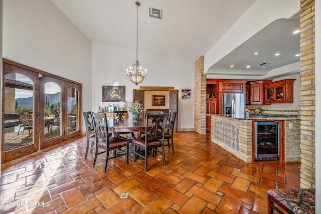 dining room featuring wine cooler and a notable chandelier