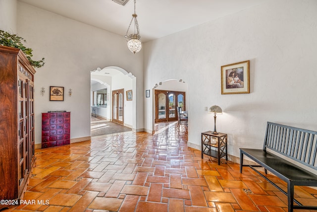 foyer with a towering ceiling and a chandelier