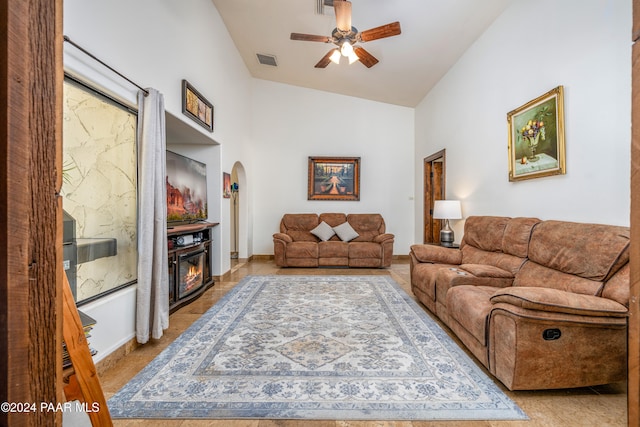 tiled living room with vaulted ceiling and ceiling fan