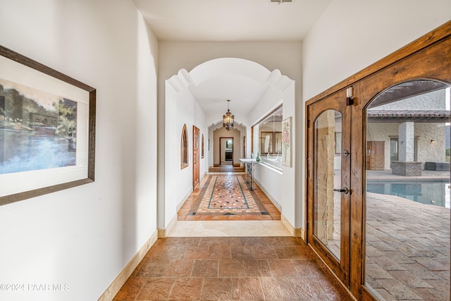 hallway featuring an inviting chandelier