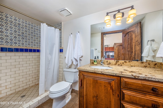 bathroom with tile patterned flooring, a shower with curtain, vanity, and toilet