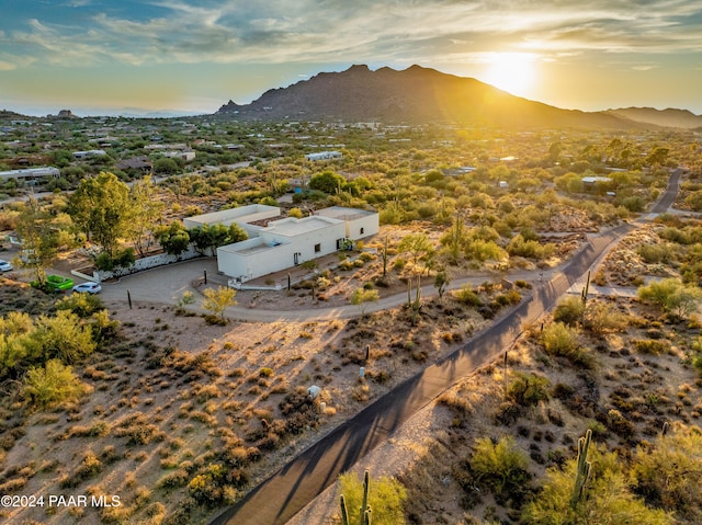 aerial view at dusk featuring a mountain view