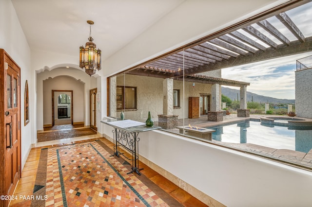 interior space with a mountain view, tile patterned flooring, and an inviting chandelier