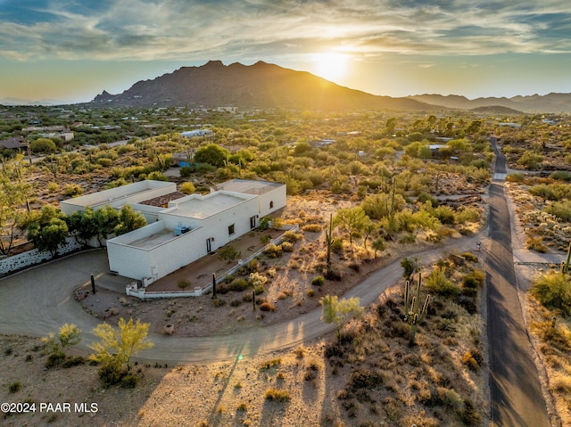 aerial view at dusk featuring a mountain view