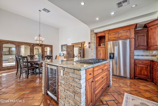 kitchen featuring decorative backsplash, stainless steel appliances, decorative light fixtures, an inviting chandelier, and wine cooler