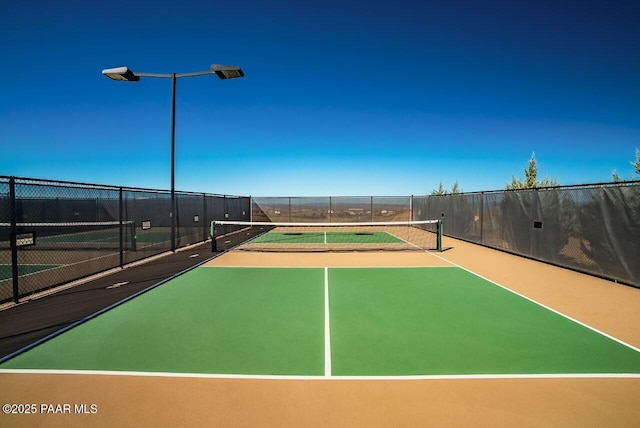 view of tennis court with fence