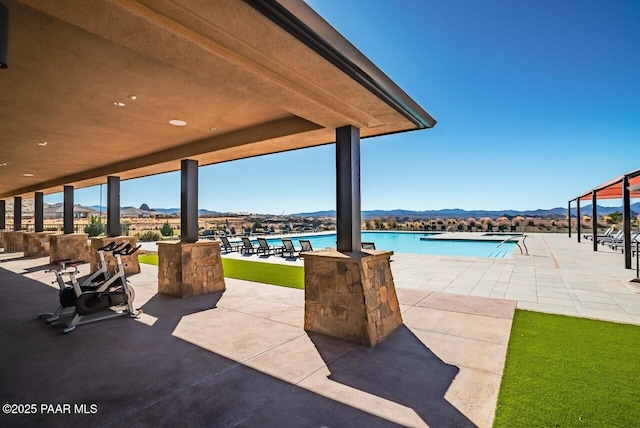 view of patio featuring a mountain view and a community pool