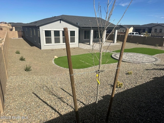 back of property with a patio area, a fenced backyard, and stucco siding