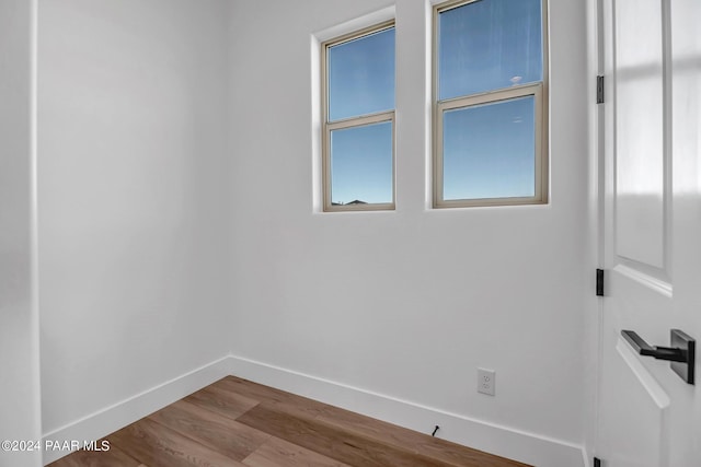 empty room featuring baseboards and wood finished floors