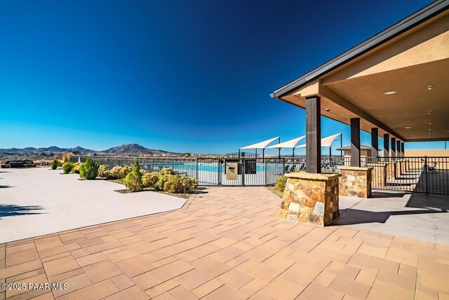 view of patio / terrace featuring a fenced in pool, a mountain view, and fence