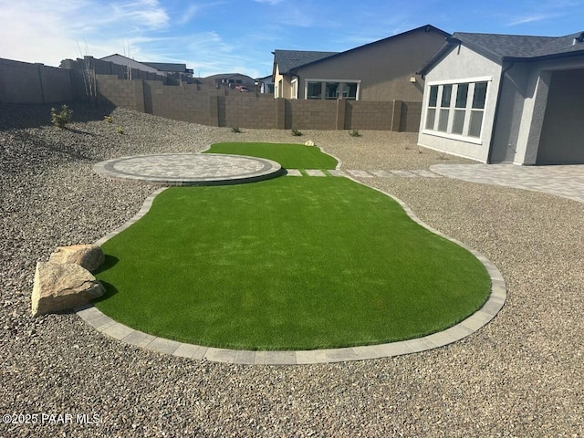 view of yard featuring a patio area and a fenced backyard