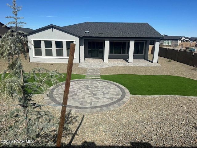 back of property featuring a patio area, a fenced backyard, roof with shingles, and stucco siding