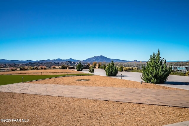 view of community featuring fence and a mountain view