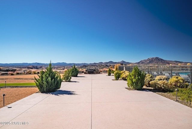 exterior space featuring fence and a mountain view