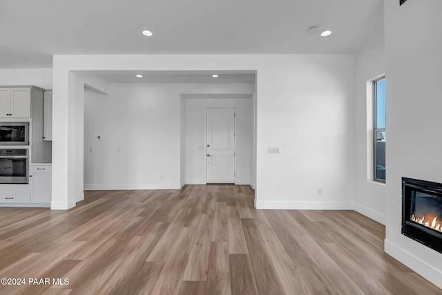 unfurnished living room featuring light hardwood / wood-style flooring