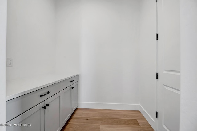 interior space featuring wood finished floors and baseboards