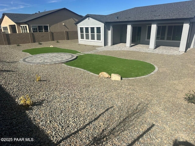 back of property featuring stucco siding, a fenced backyard, and a patio