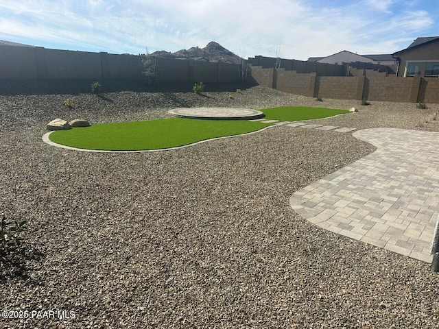 view of yard featuring a patio and a fenced backyard