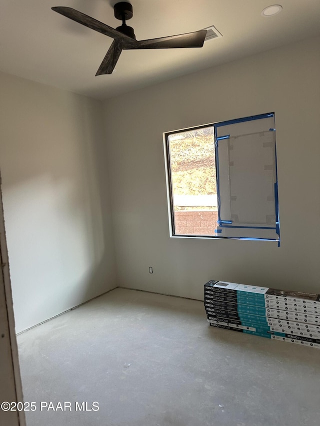 empty room featuring ceiling fan and concrete flooring
