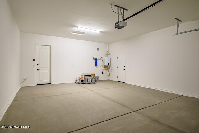 garage featuring a garage door opener and water heater