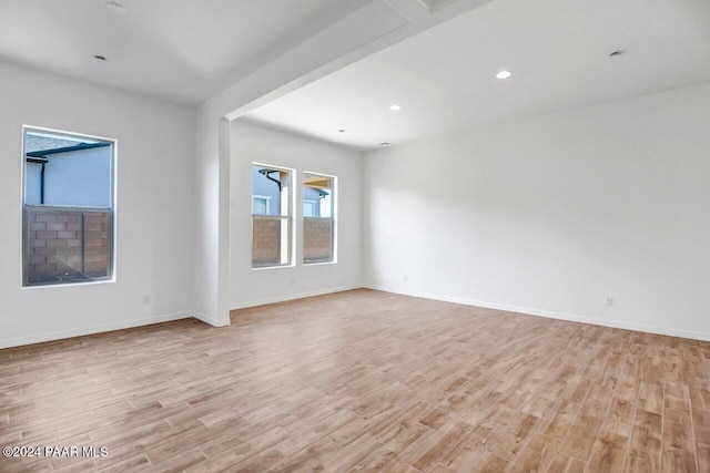 empty room with light hardwood / wood-style flooring